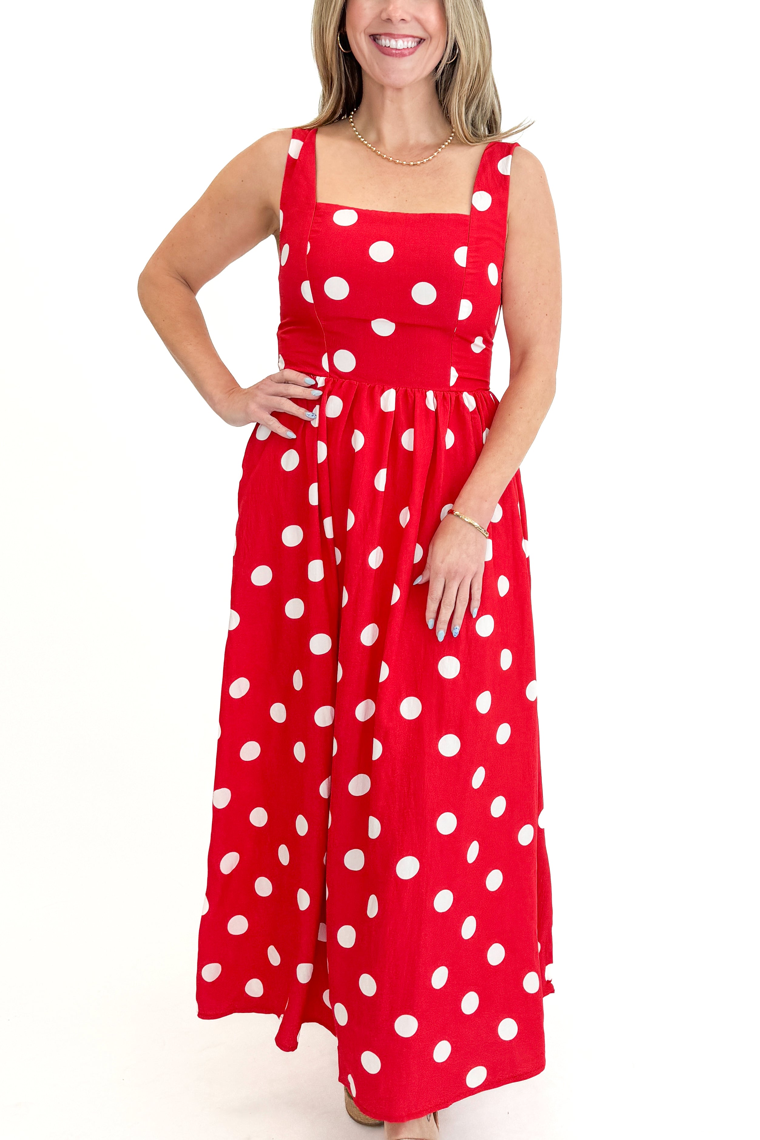 Front detail view of woman wearing Red & White Polka Dot Midi Dress against white studio background.