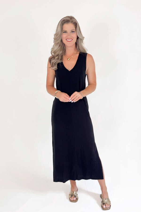 Woman wearing a black sleeveless dress on a white background