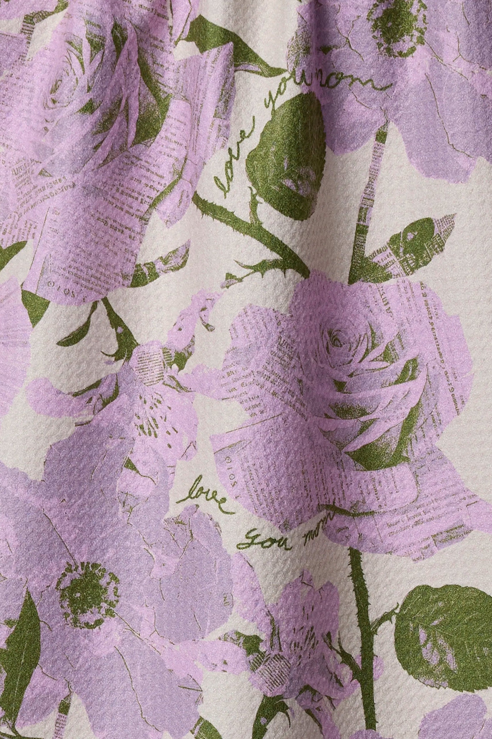 Floral pattern with purple flowers and green leaves on a light background