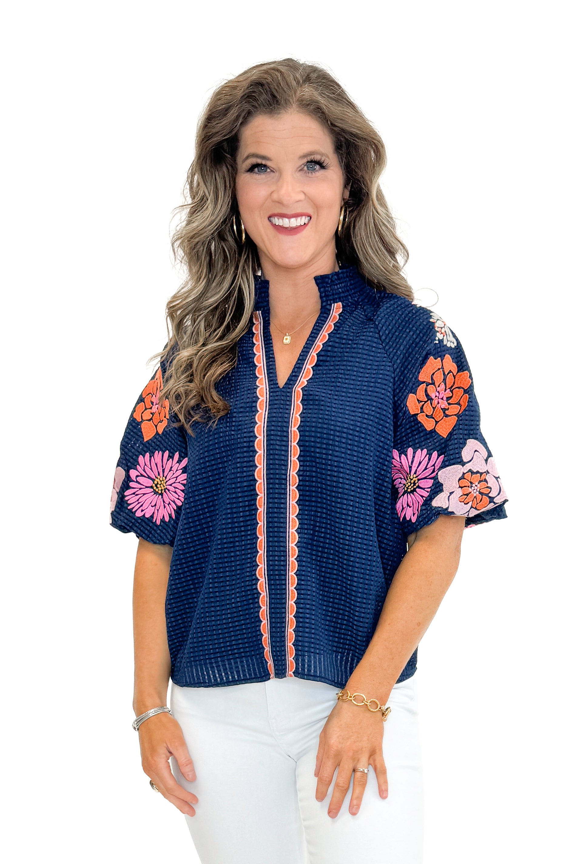 Front view of woman wearing Navy Textured & Floral Embroidered Top by THML with jeans against white studio background.