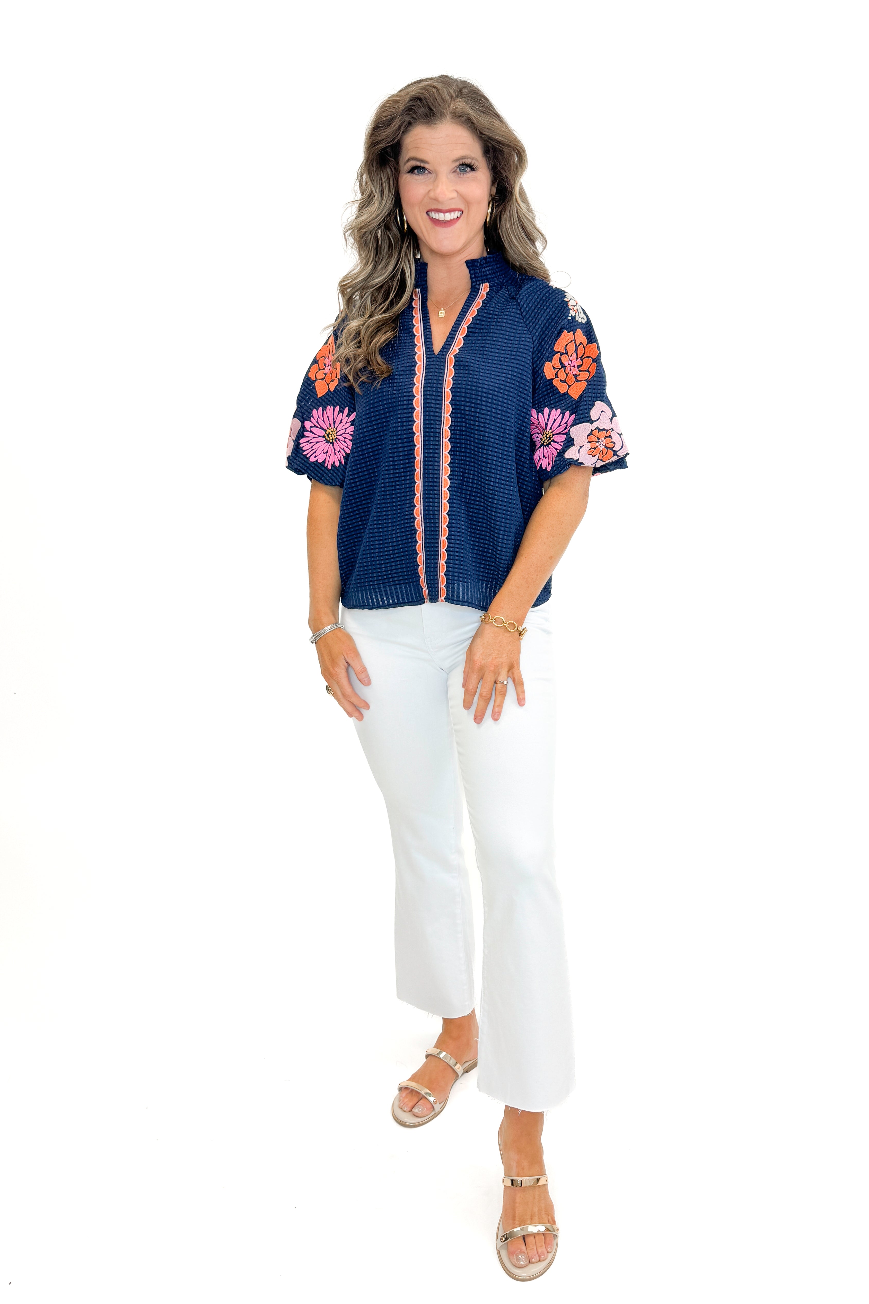 Front view of woman wearing Navy Textured & Floral Embroidered Top by THML with jeans against white studio background.