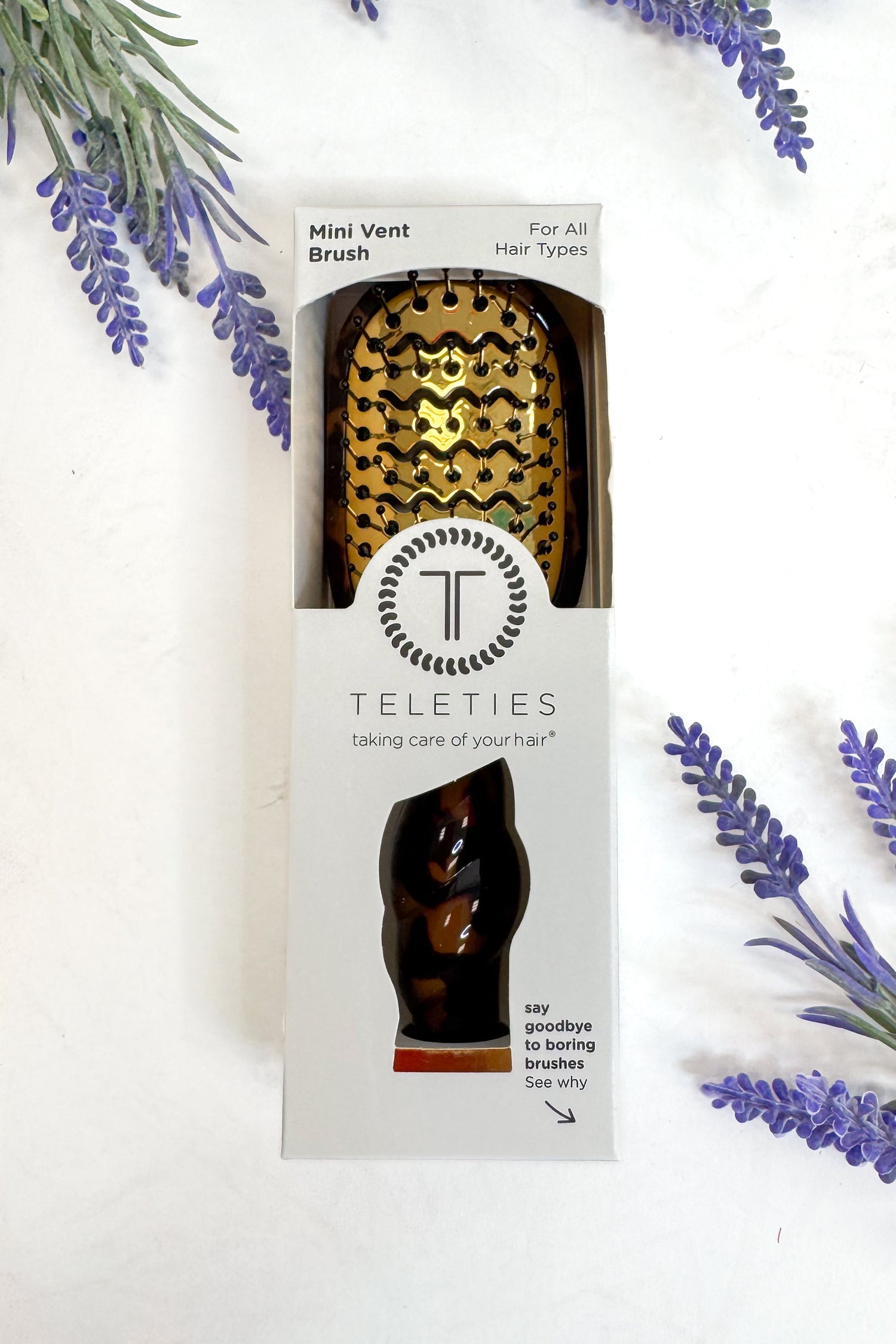 Teleties mini vent brush packaging with decorative lavender on a white background