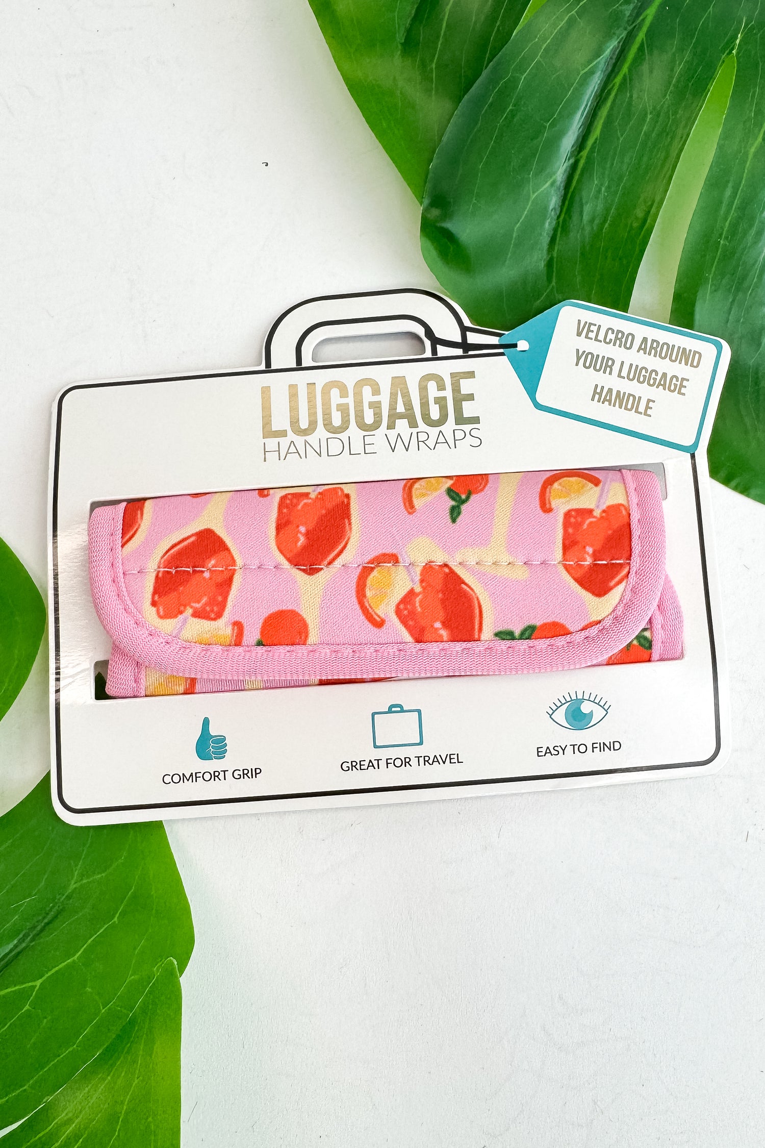 Luggage handle wrap with pink floral design on a white background