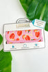 Luggage handle wrap with pink floral design on a white background