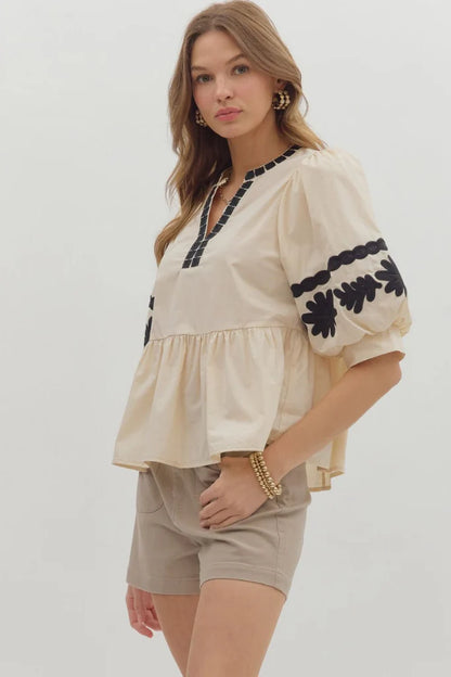 In Good Spirits Ecru With Black Embroidered Sleeve Peplum Top by Entro
