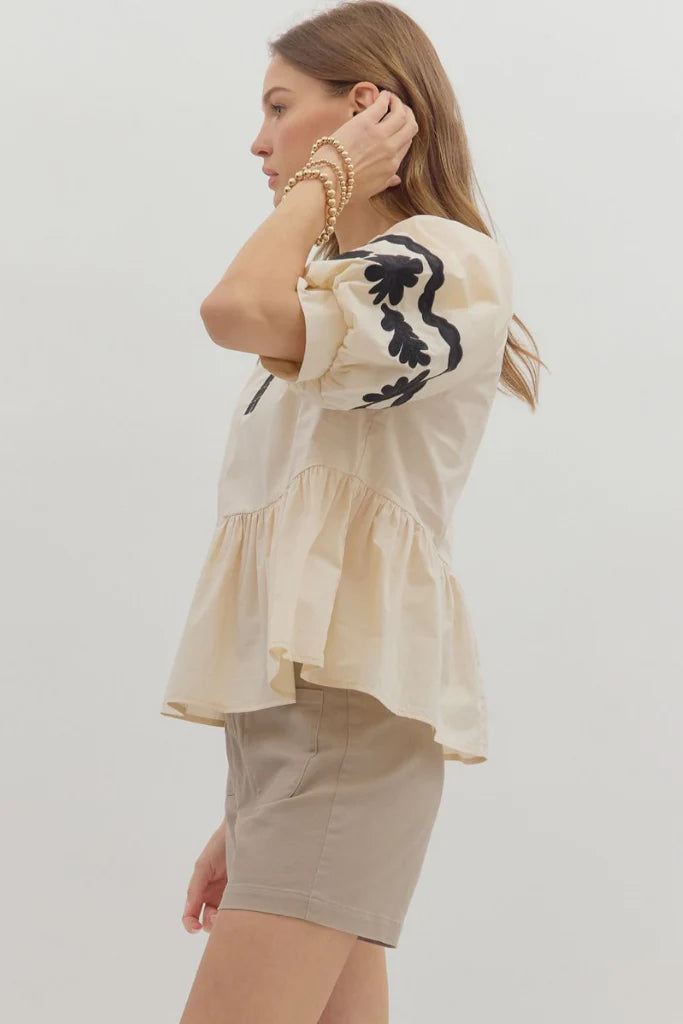 In Good Spirits Ecru With Black Embroidered Sleeve Peplum Top by Entro