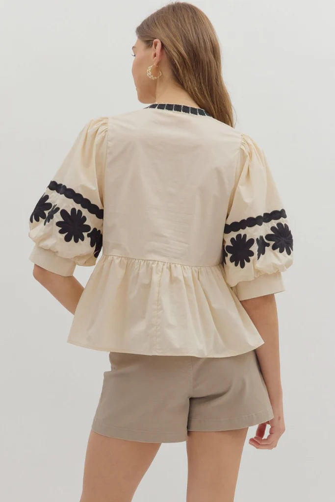 In Good Spirits Ecru With Black Embroidered Sleeve Peplum Top by Entro