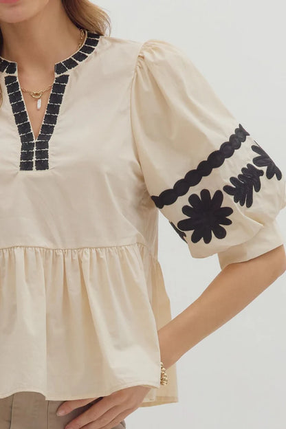 In Good Spirits Ecru With Black Embroidered Sleeve Peplum Top by Entro