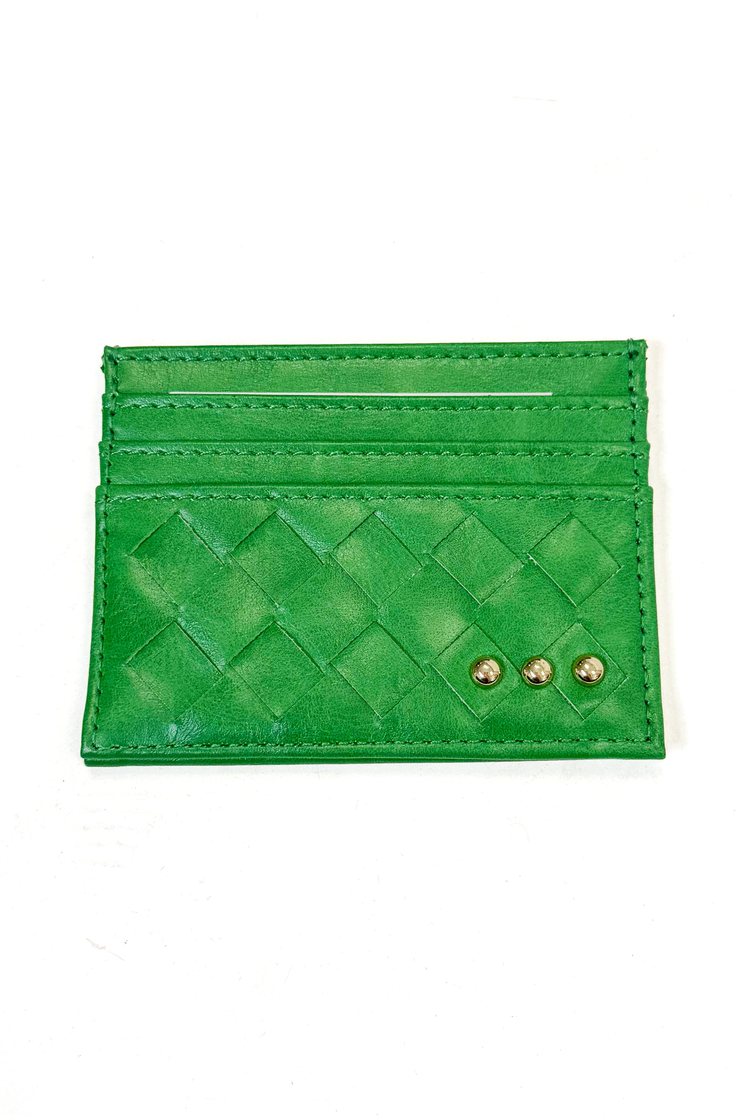 A green woven leather card holder wallet with two gold-tone metal studs on the front, displayed flat against a white background.