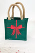 Green gift bag with a red bow design on a white background