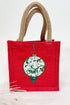 Red jute bag with a decorative green ornament on a white background