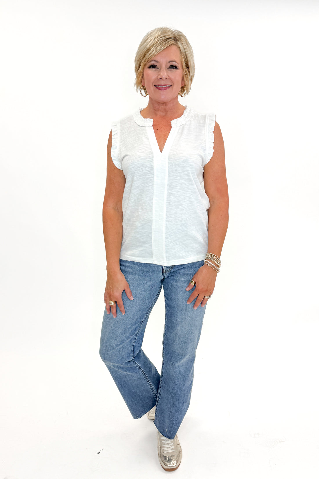 Front view of woman wearing Off White Frill Detail V-Neck Tank with jeans against white studio background.