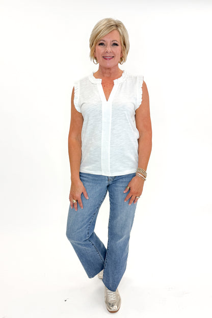 Front view of woman wearing Off White Frill Detail V-Neck Tank with jeans against white studio background.