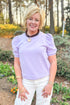 Front view of woman wearing Lavender Short Sleeve Sweatshirt with jeans outside at a garden.