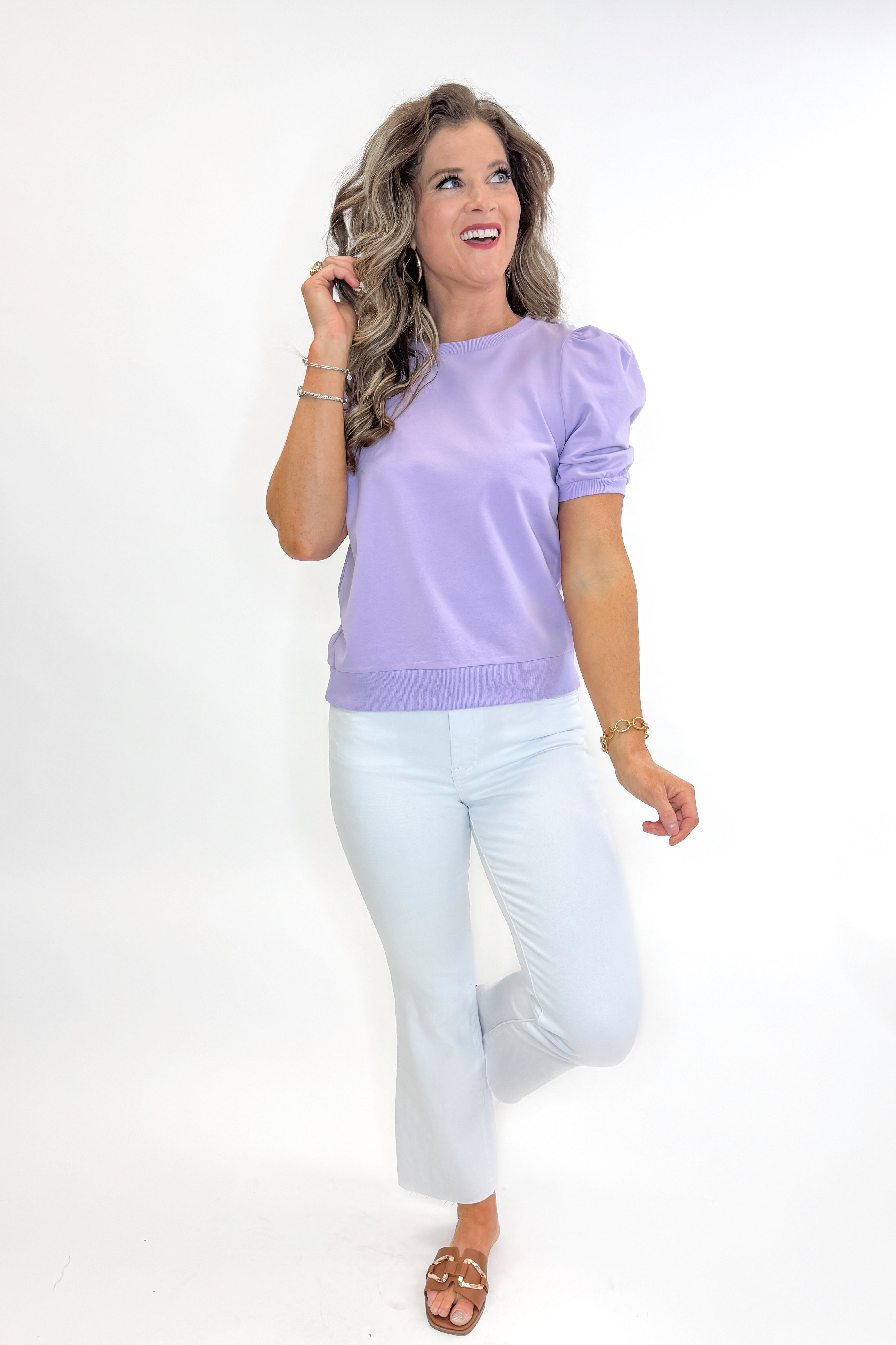 Front view of woman wearing Lavender Short Sleeve Sweatshirt with jeans against white studio background.