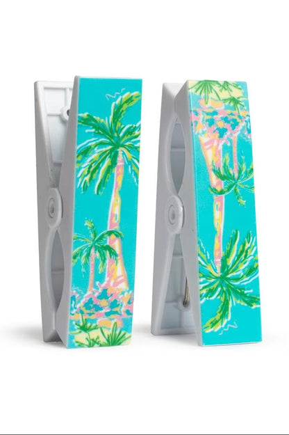 Two beach towel cups with tropical palm tree design on a white background