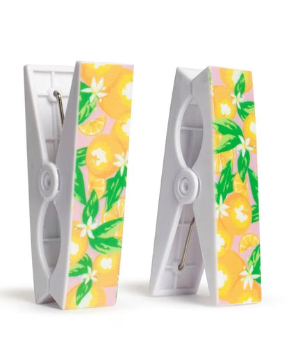 Two beach towel clips with floral patterns on a white background