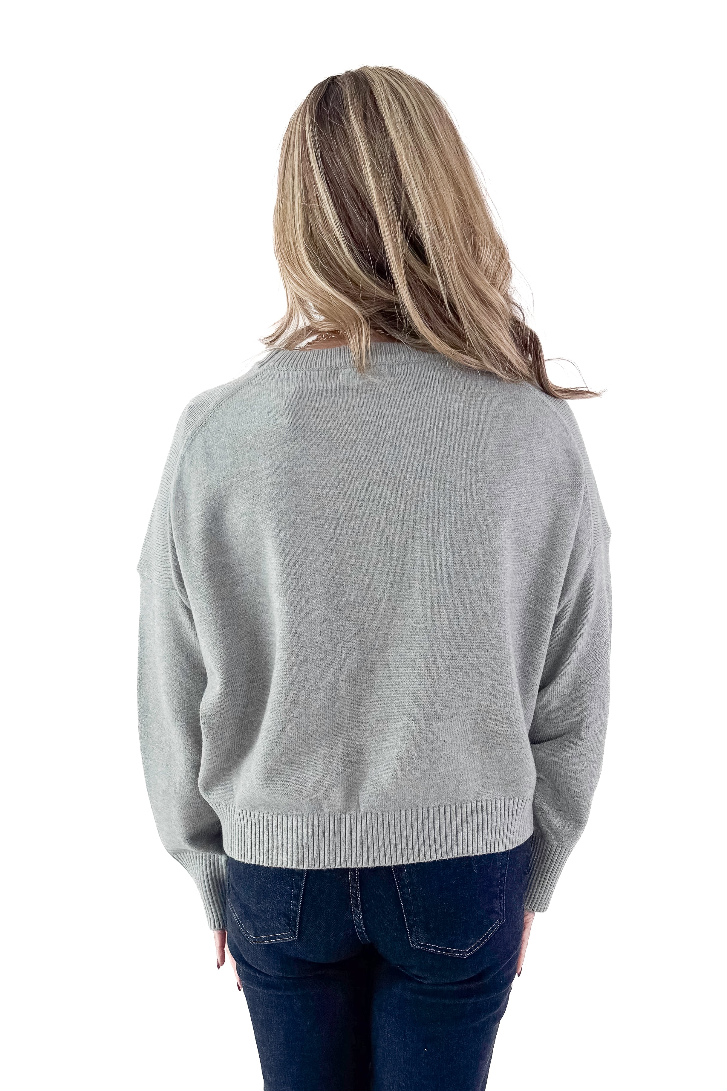 Back view of woman wearing Light Grey Crewneck Sweater with Ruched Sleeve with jeans against white studio background.
