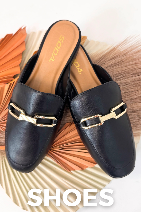 Black loafers with gold accents on a decorative surface with "SHOES" overlay