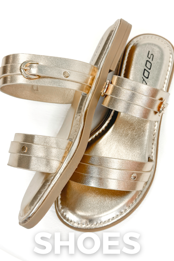 Pair of gold sandals on a white background with 'SODA' branding.