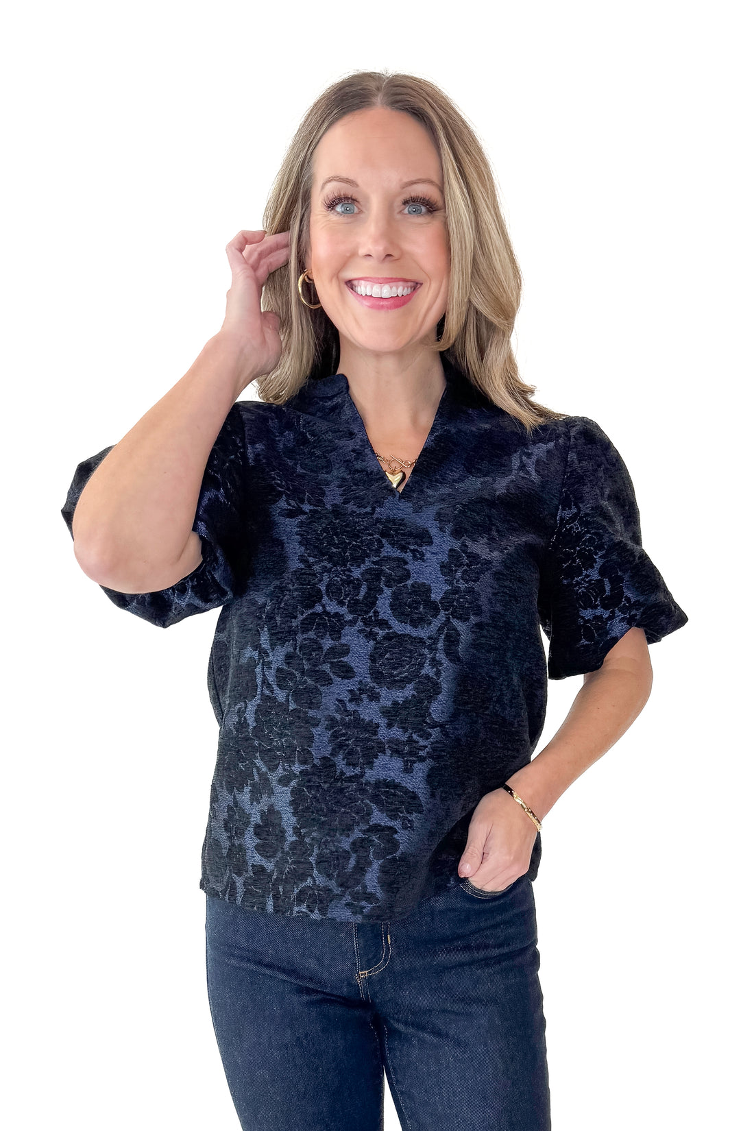 Front view of woman wearing Navy Floral Velvet Jacquard Top with jeans against white studio background.