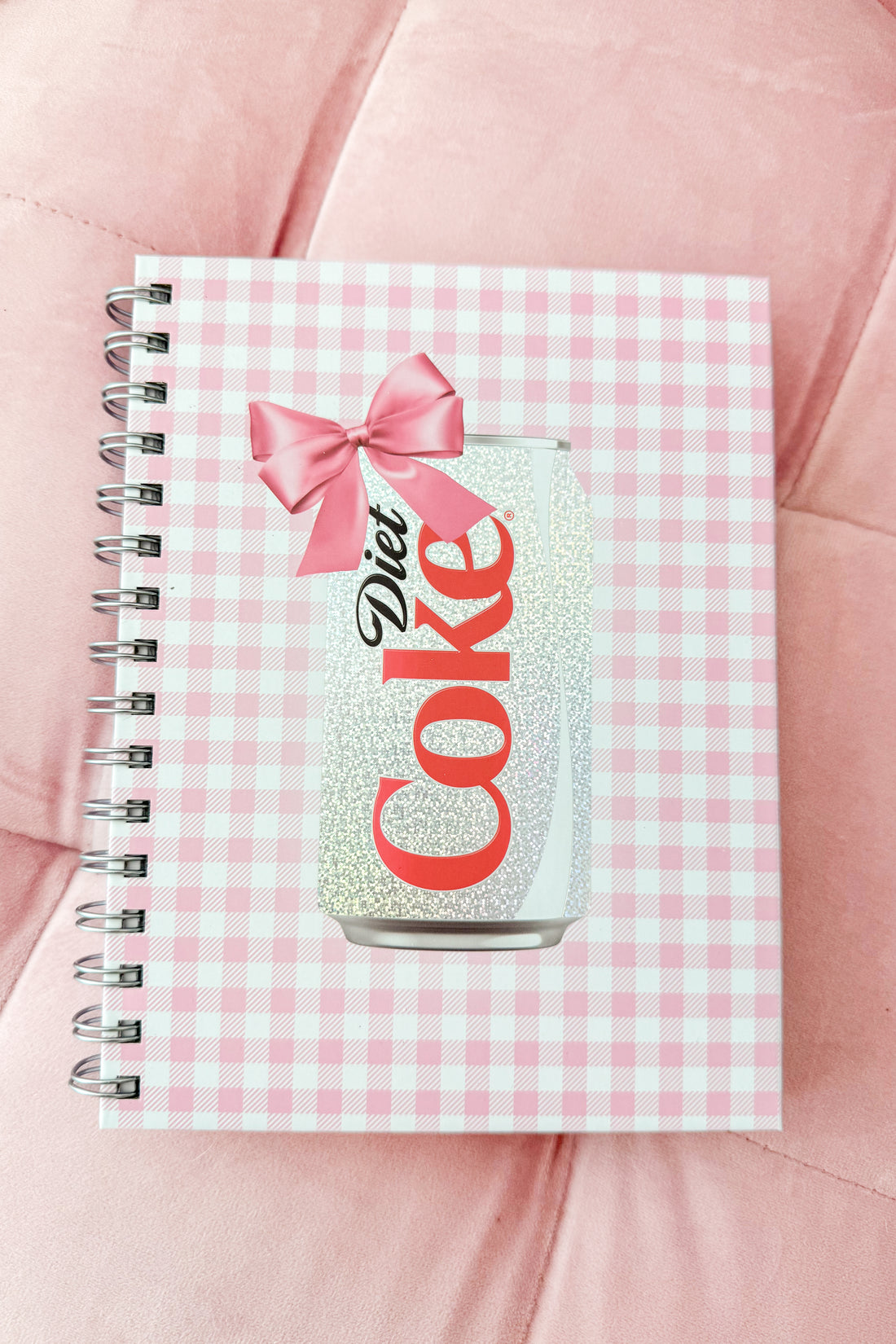 Notebook with Diet Coke design on a pink checkered background