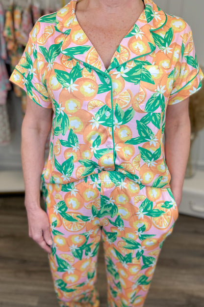Person wearing a colorful pajama set with orange and green pattern