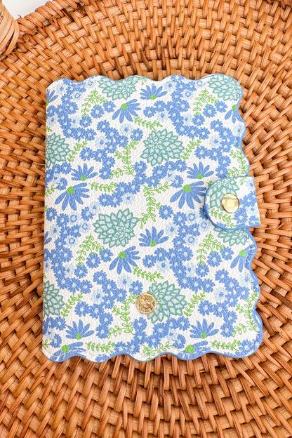 Floral-patterned passport cover on a woven surface