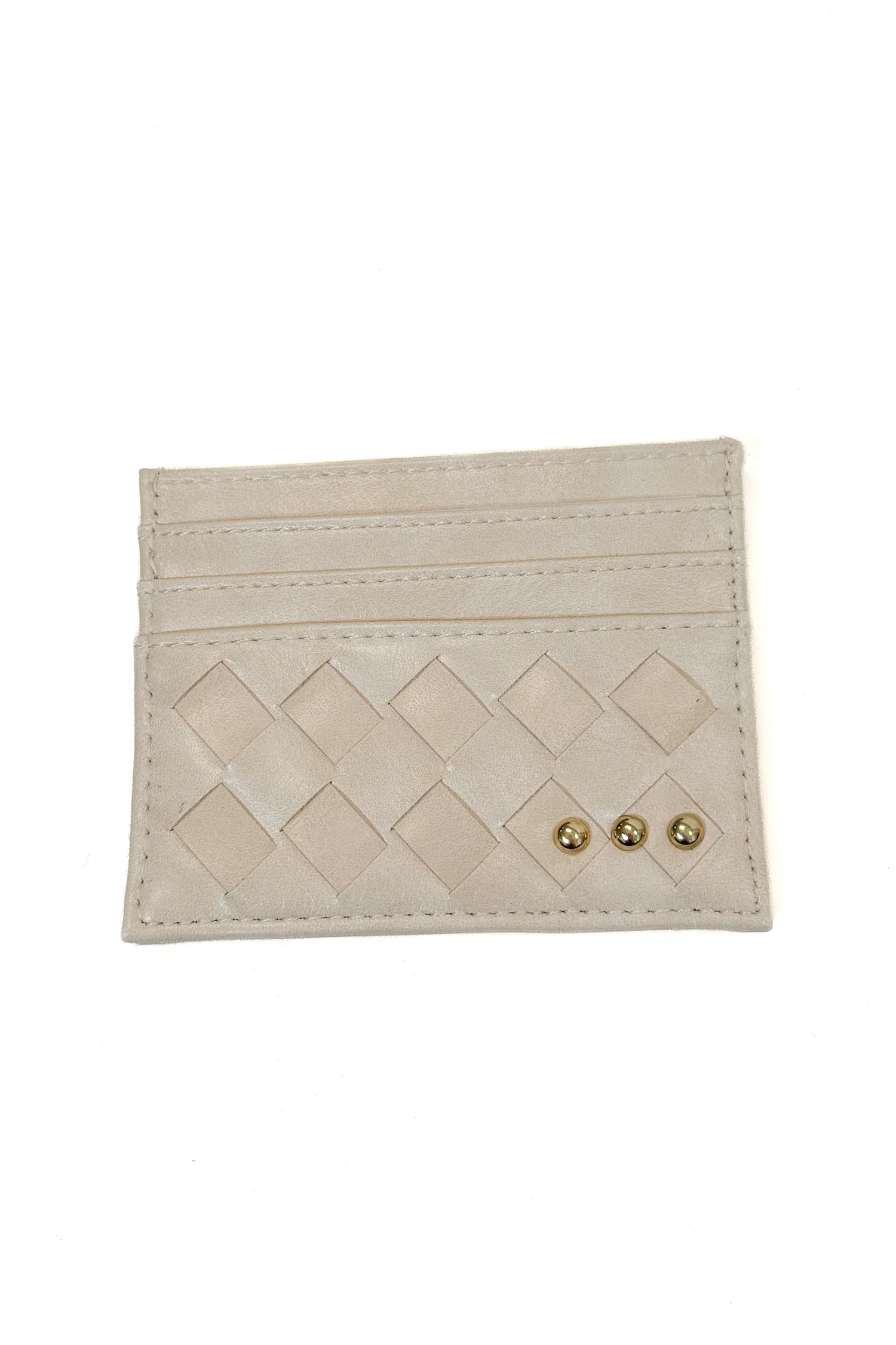 A light beige leather card holder with a diamond-quilted pattern and three small gold-tone studs, shown on a plain white background.
