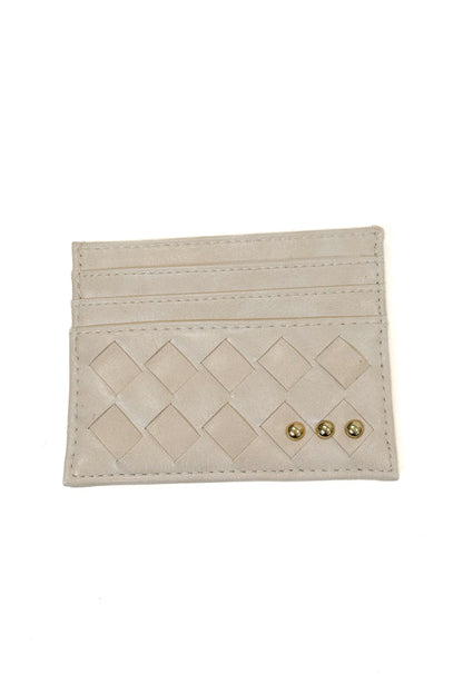 A light beige leather card holder with a diamond-quilted pattern and three small gold-tone studs, shown on a plain white background.