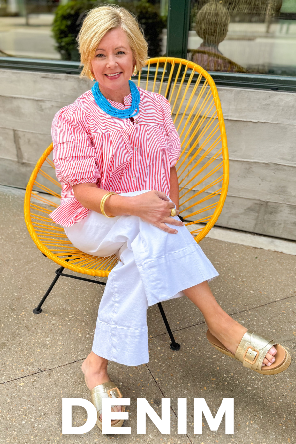 Woman in colorful top sitting in yellow chair with 'Denim' text.