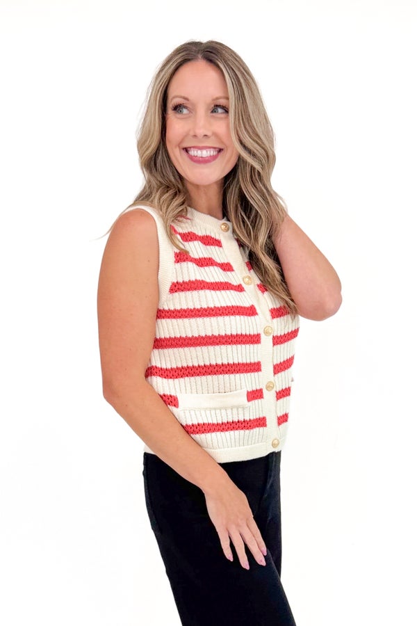 Woman wearing a red and white striped sleeveless top on a white background