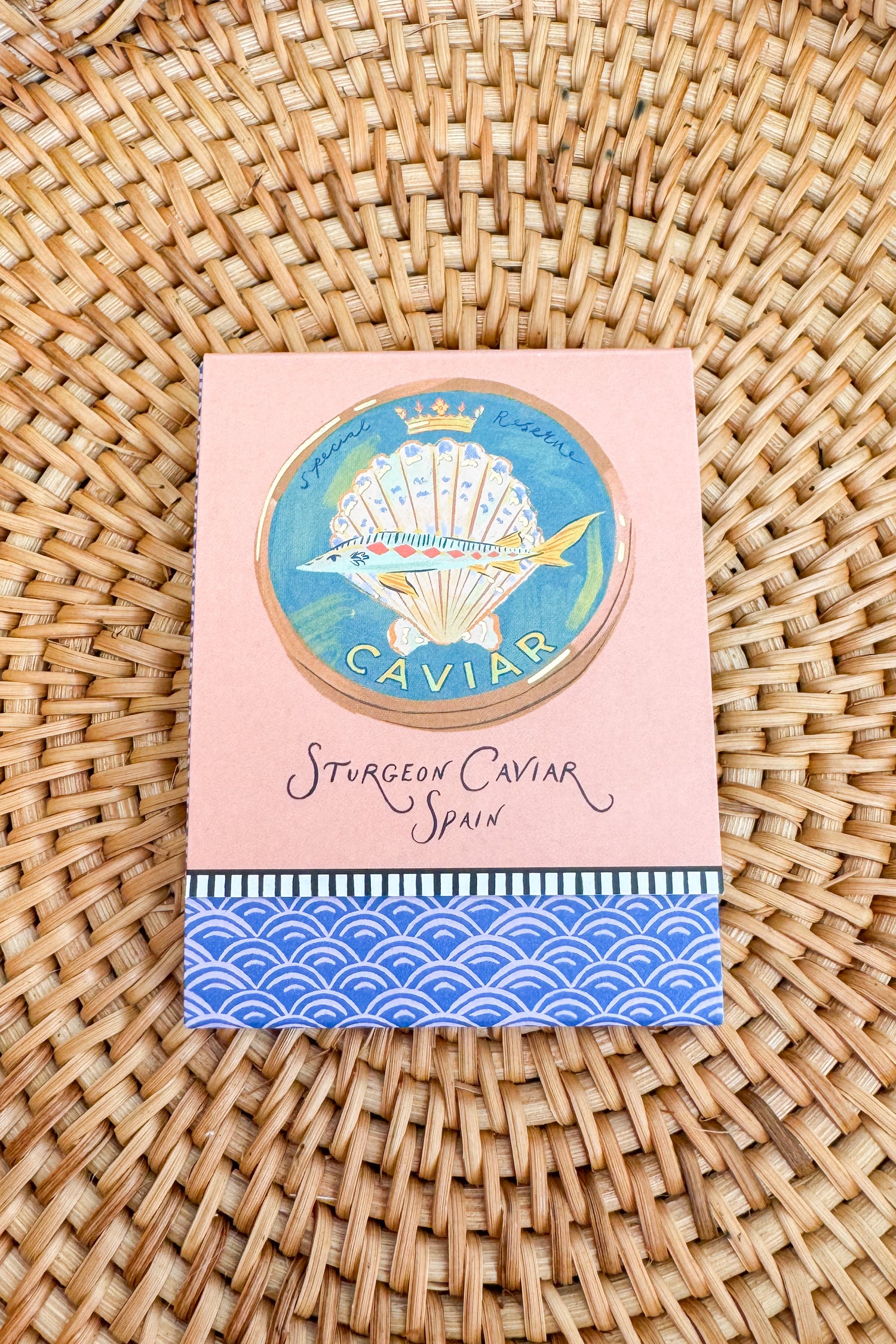 Caviar packaging with decorative design on a woven surface