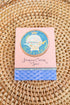 Caviar packaging with decorative design on a woven surface
