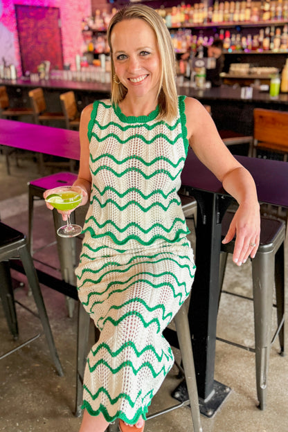 Front view of woman wearing Ivory &amp; Green Scalloped Tank by Skies Are Blue with matching skirt at a bar.