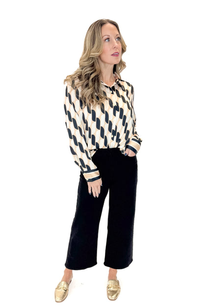 Front view of woman wearing Cream &amp; Black Abstract Print Button Up Top with jeans against white studio background.