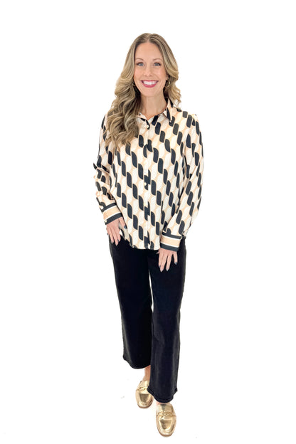 Front view of woman wearing Cream &amp; Black Abstract Print Button Up Top with jeans against white studio background.