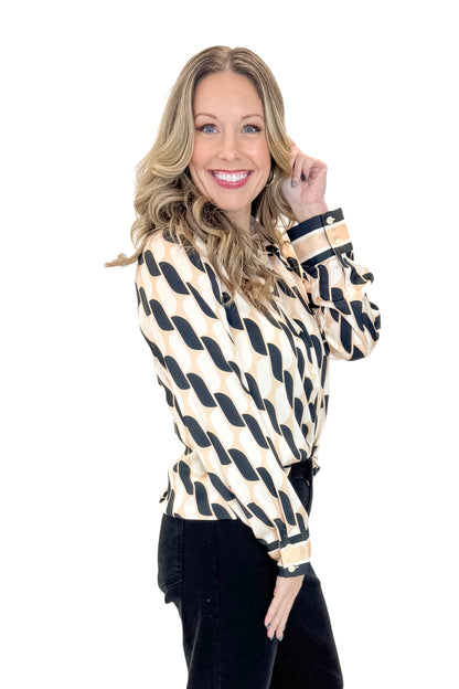 Side view of woman wearing Cream &amp; Black Abstract Print Button Up Top with jeans against white studio background.