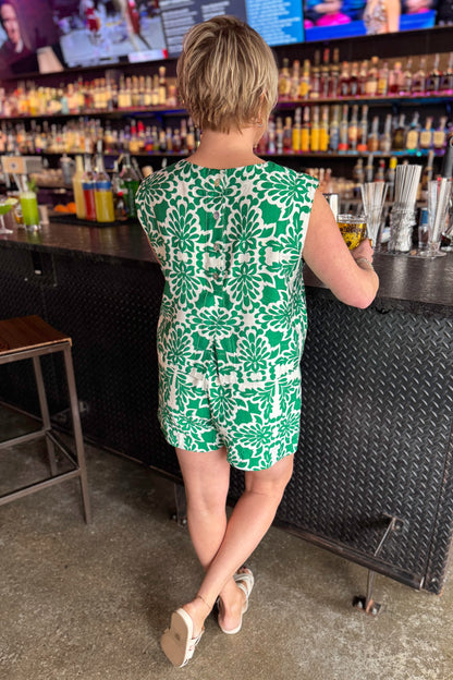 Back view of woman wearing Green &amp; Ivory Printed Tank by Skies Are Blue with matching shorts at a bar.