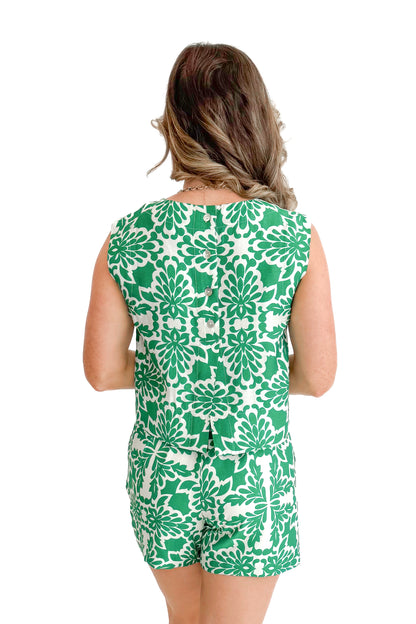 Back view of woman wearing Green &amp; Ivory Printed Tank by Skies Are Blue with matching shorts against white studio background.