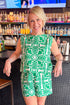 Front view of woman wearing Green & Ivory Printed Tank by Skies Are Blue with matching shorts at a bar.