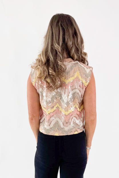 Back view of woman wearing Blush &amp; Multi Sequin Tank Top with jeans against white studio background.