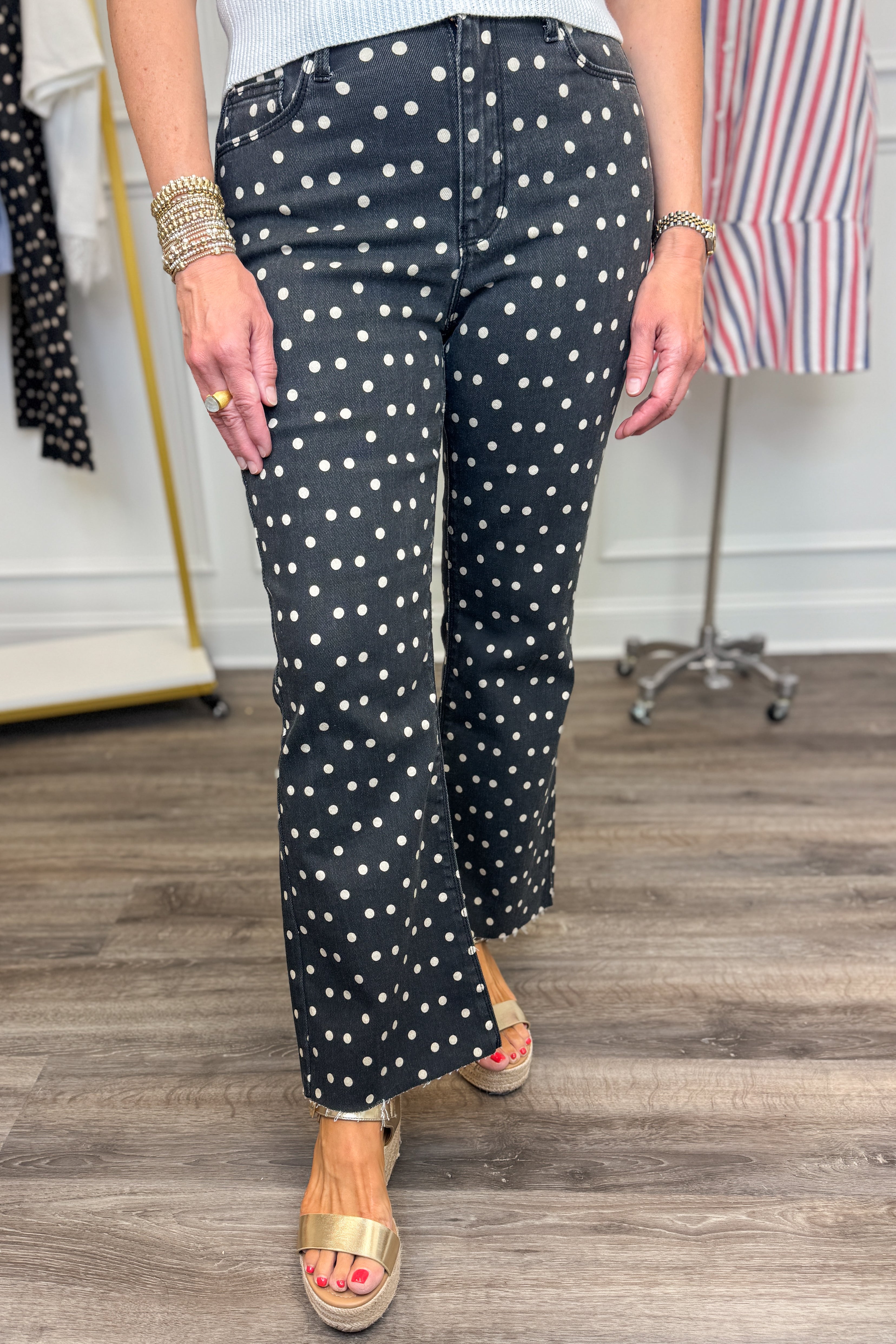 Front detail view of woman wearing Swagger Boutique’s Black &amp; White Polka Dot Crop Flare Jeans by Just Black Denim with top against white studio background.