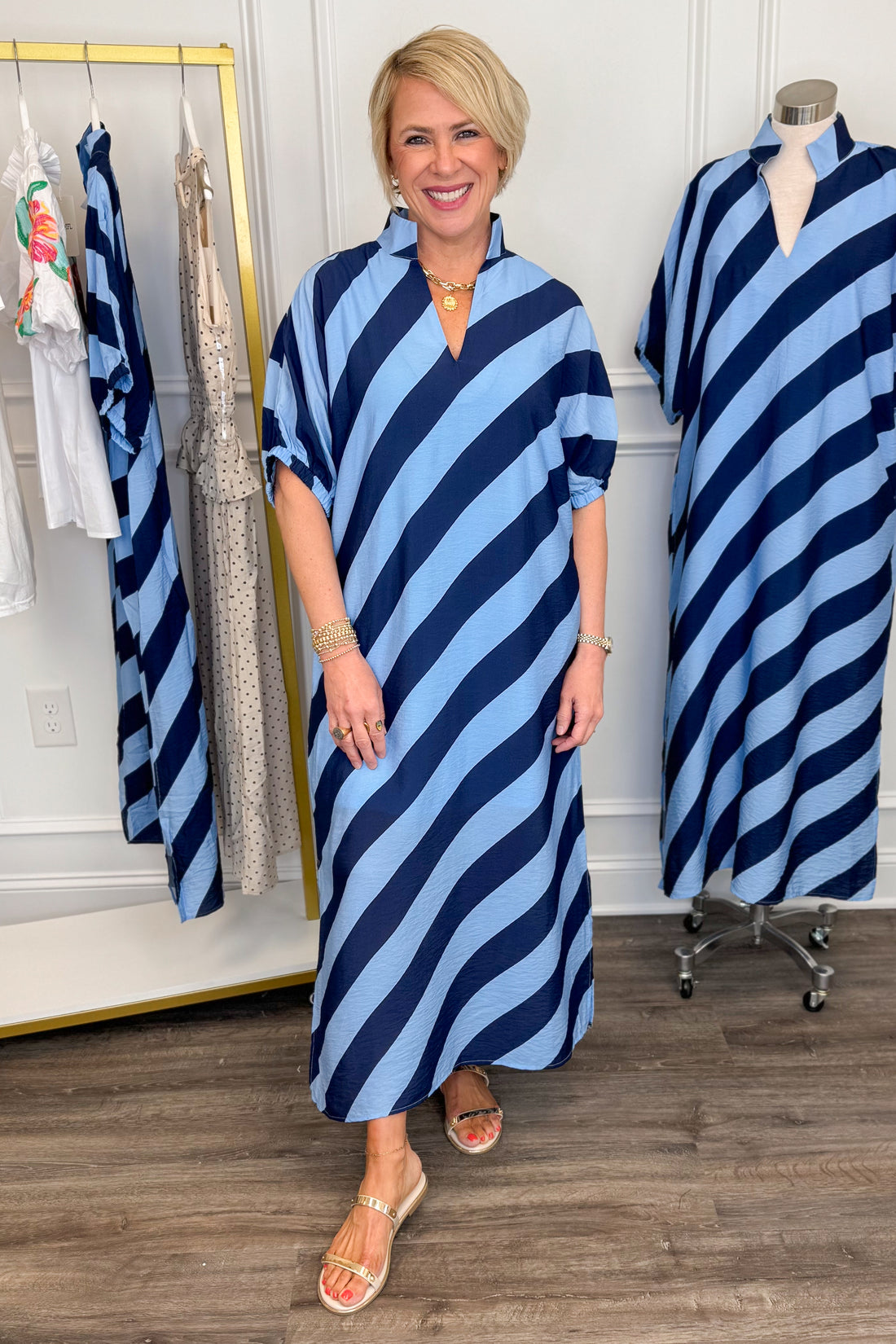 Front view of woman wearing Navy &amp; Light Blue Diagonal Striped Midi Dress by Entro with gold sandals. 