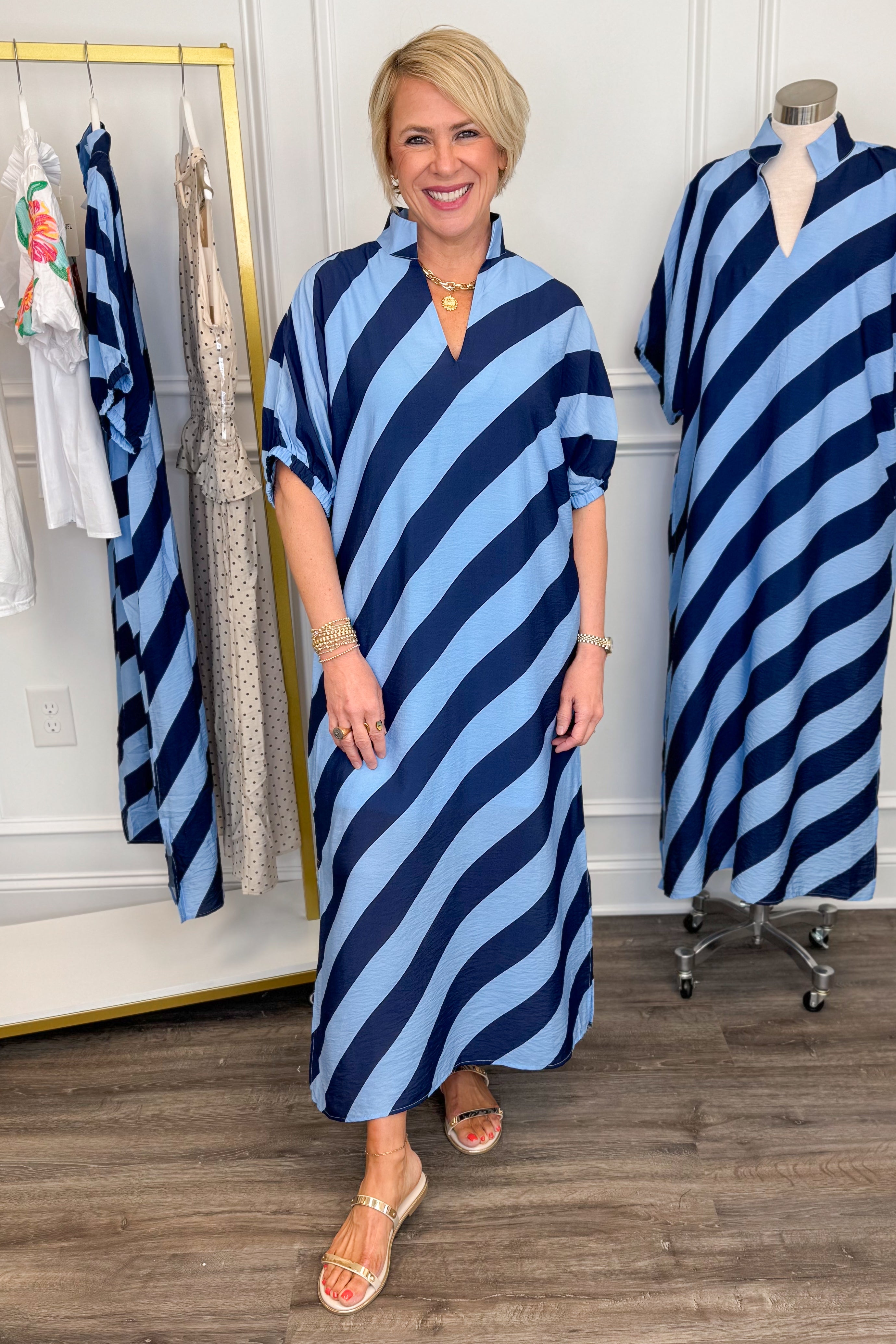 Front view of woman wearing Navy &amp; Light Blue Diagonal Striped Midi Dress by Entro with gold sandals. 