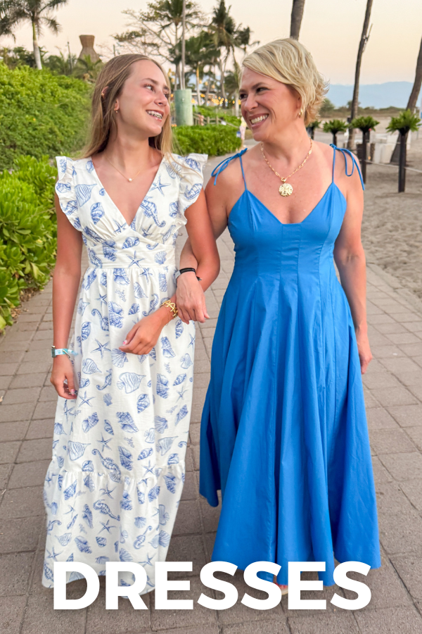 Two women in dresses standing on a path with 'DRESSES' text overlay.