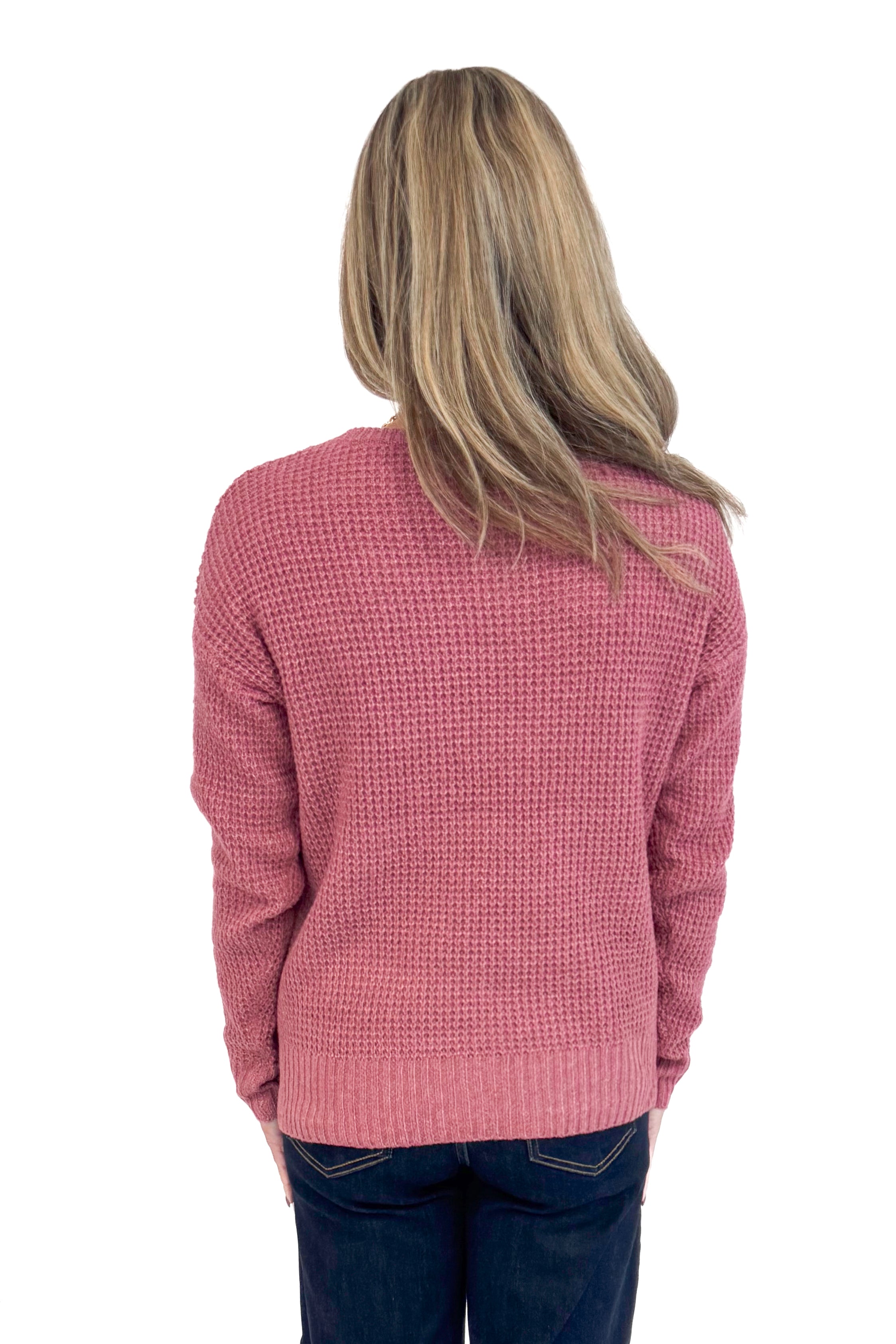 Back picture of woman wearing Rose Waffle Knit Sweater and jeans. 