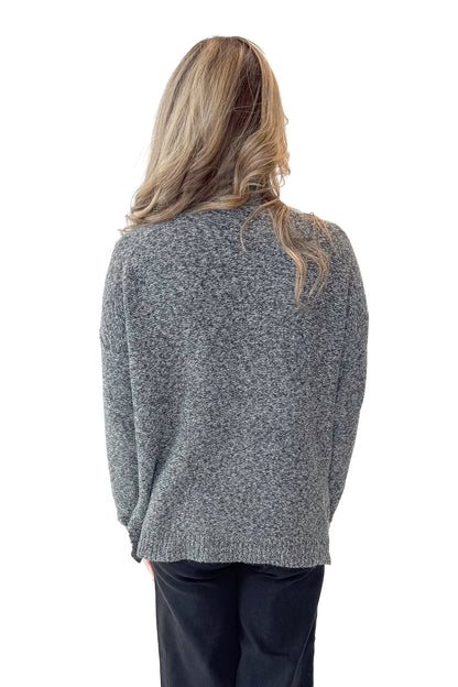 Back view of woman wearing Black &amp; Cream Marled Mock Neck Sweater with jeans against white studio background.