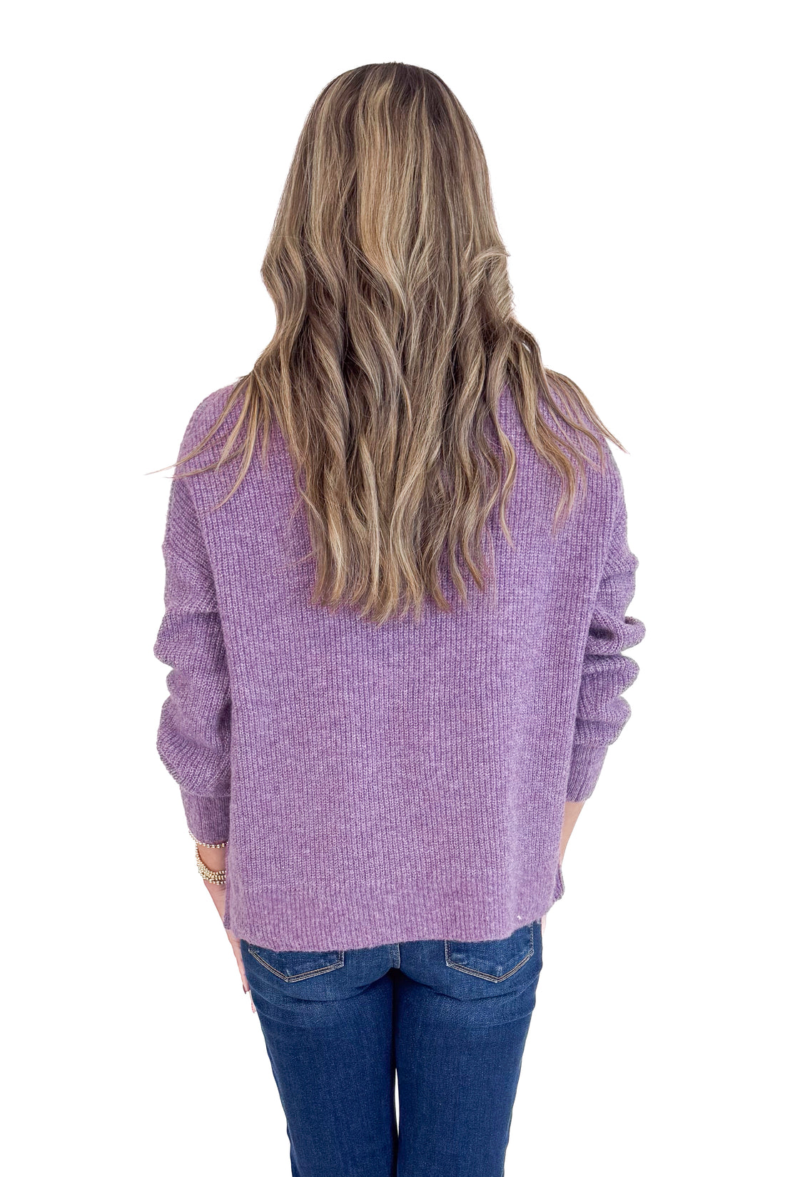 Person wearing a purple sweater from behind on a white background