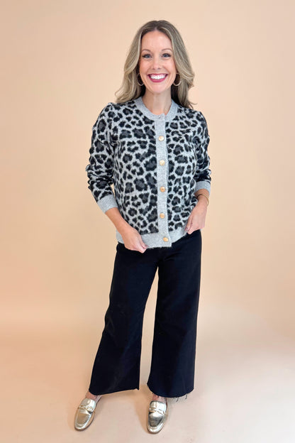 Front view of woman wearing Grey Leopard Button Up Cardigan and black jeans.